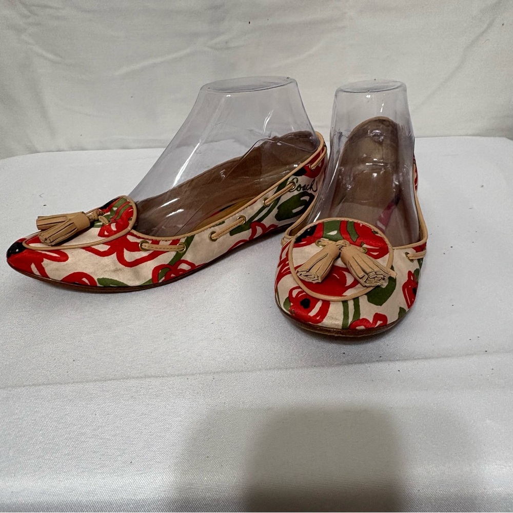 Coach women's flats with a floral print and tassel detail. Size 6.5